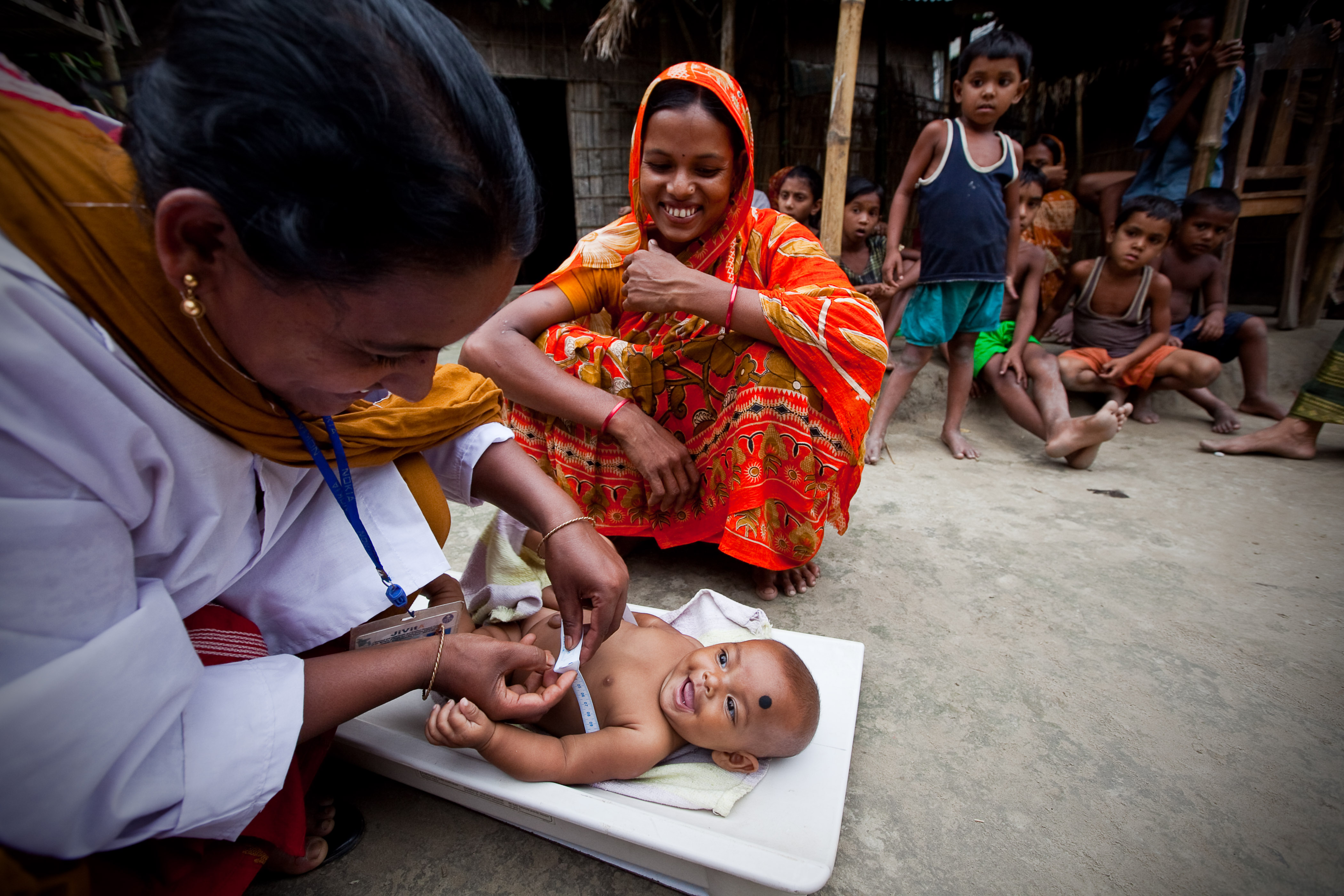 Bangladesh frontline health worker cares for baby